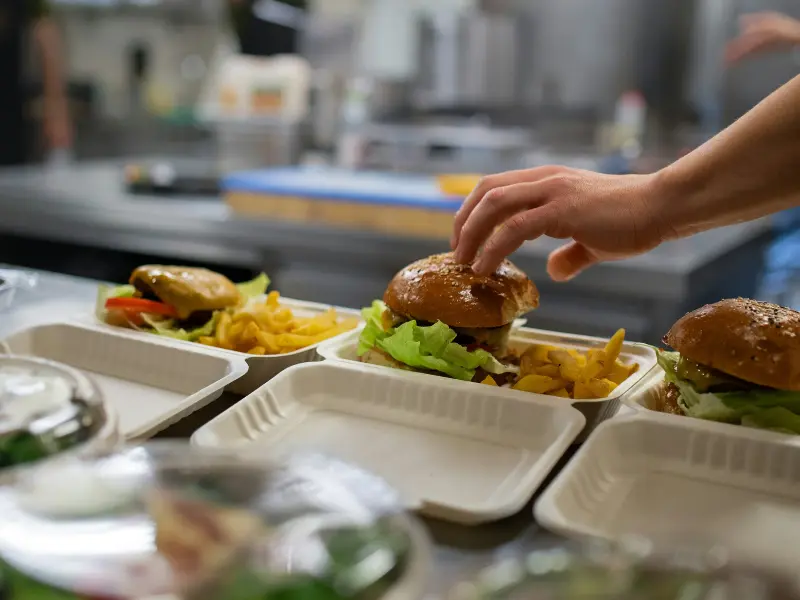 This scenario captures a moment of active food preparation and positive interaction in a professional kitche