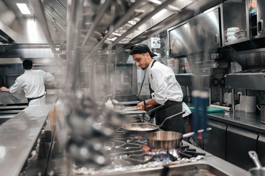 This is a candid photograph taken inside a clean, busy professional kitchen.