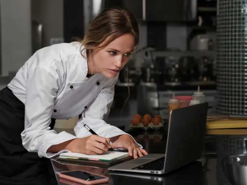 This photo depicts the administrative and managerial side of running a food business, which is a crucial aspect for entrepreneurs using a culinary incubator.