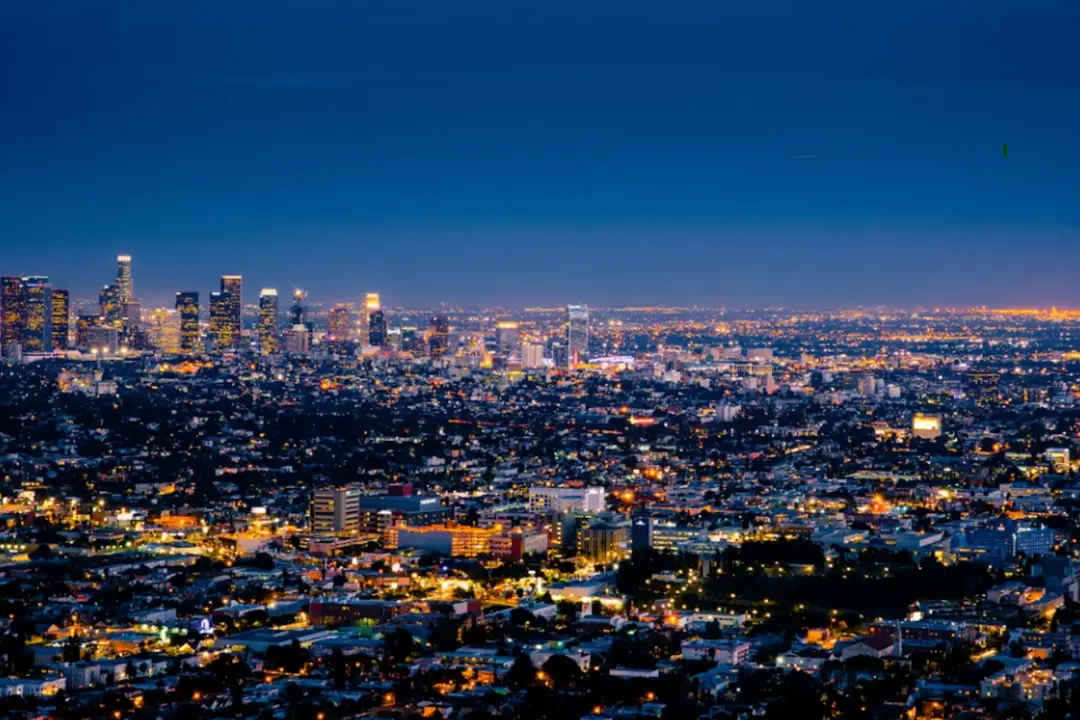 The image is a classic nighttime panorama of the city of Los Angeles, California, USA.