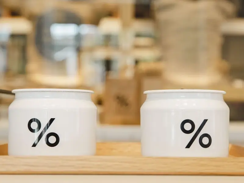 The image shows a table filled with a variety of delicious dishes, beautifully arranged for a shared meal. In the center, there is a fresh Caesar salad topped with croutons and grated cheese.