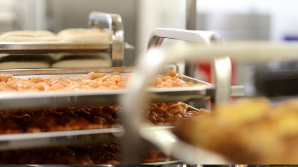 This image shows a high-volume food preparation or storage area, likely inside a commercial kitchen or catering facility.