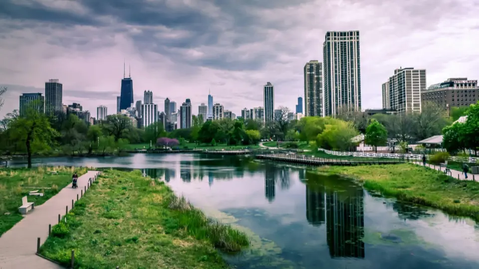 The image featuring the park and the skyline is a view of Chicago, Illinois, specifically captured from Lincoln Park.