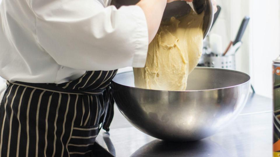 This image captures a fundamental step in the baking process within a professional kitchen or bakery.