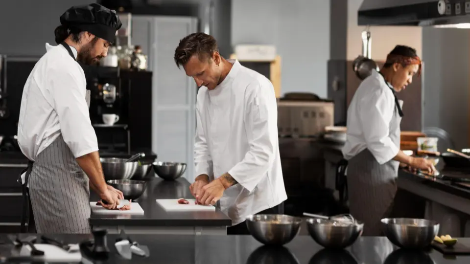 This photo illustrates the collaborative effort of a kitchen brigade during the preparation phase.