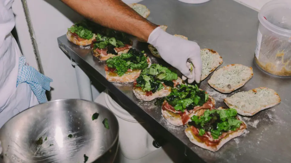 This top-down perspective shows the organized process of preparing gourmet sandwiches or bruschettas.