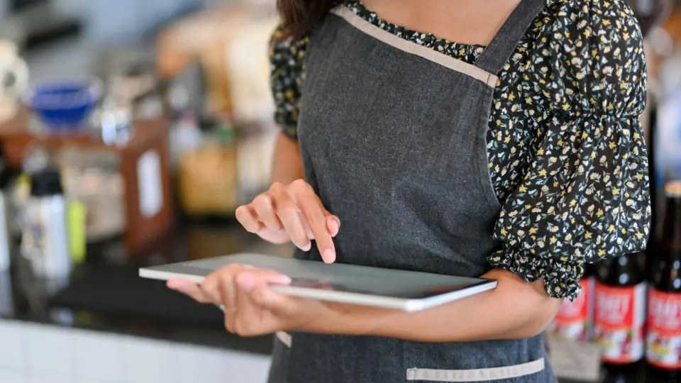 This image focuses on the integration of technology and customer service in a contemporary retail or hospitality setting.