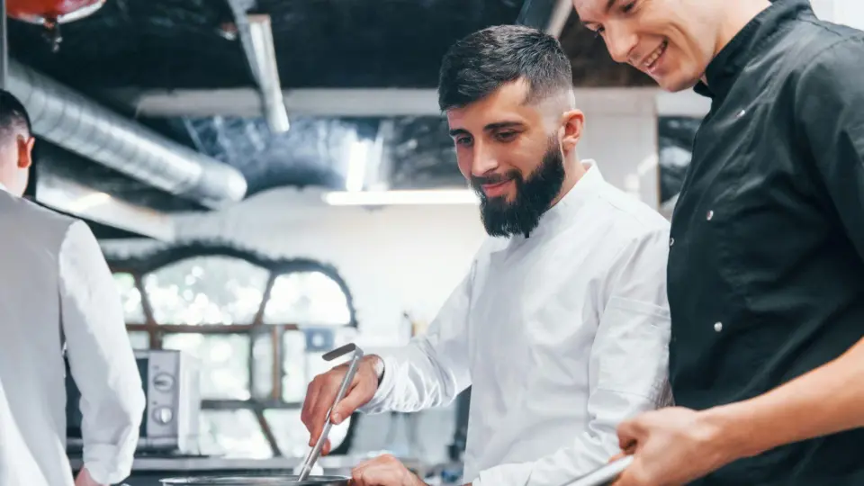 This image showcases teamwork within a professional kitchen environment.