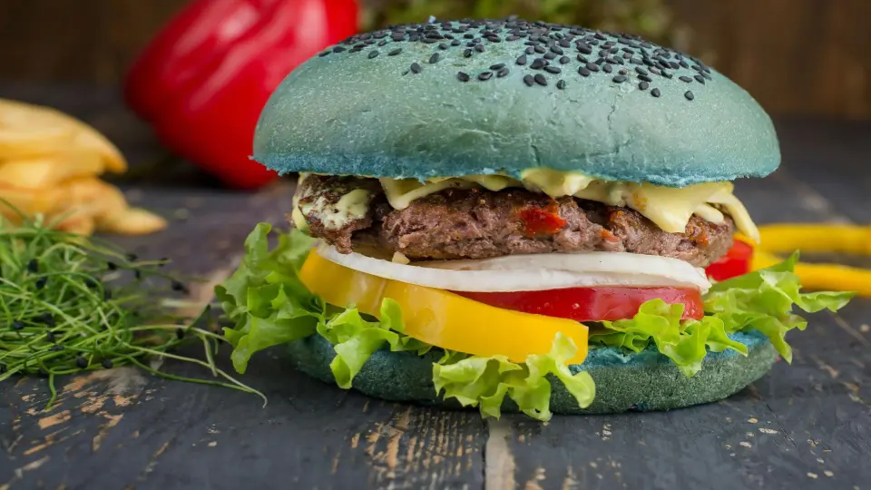 The image is a close-up of a unique gourmet burger.