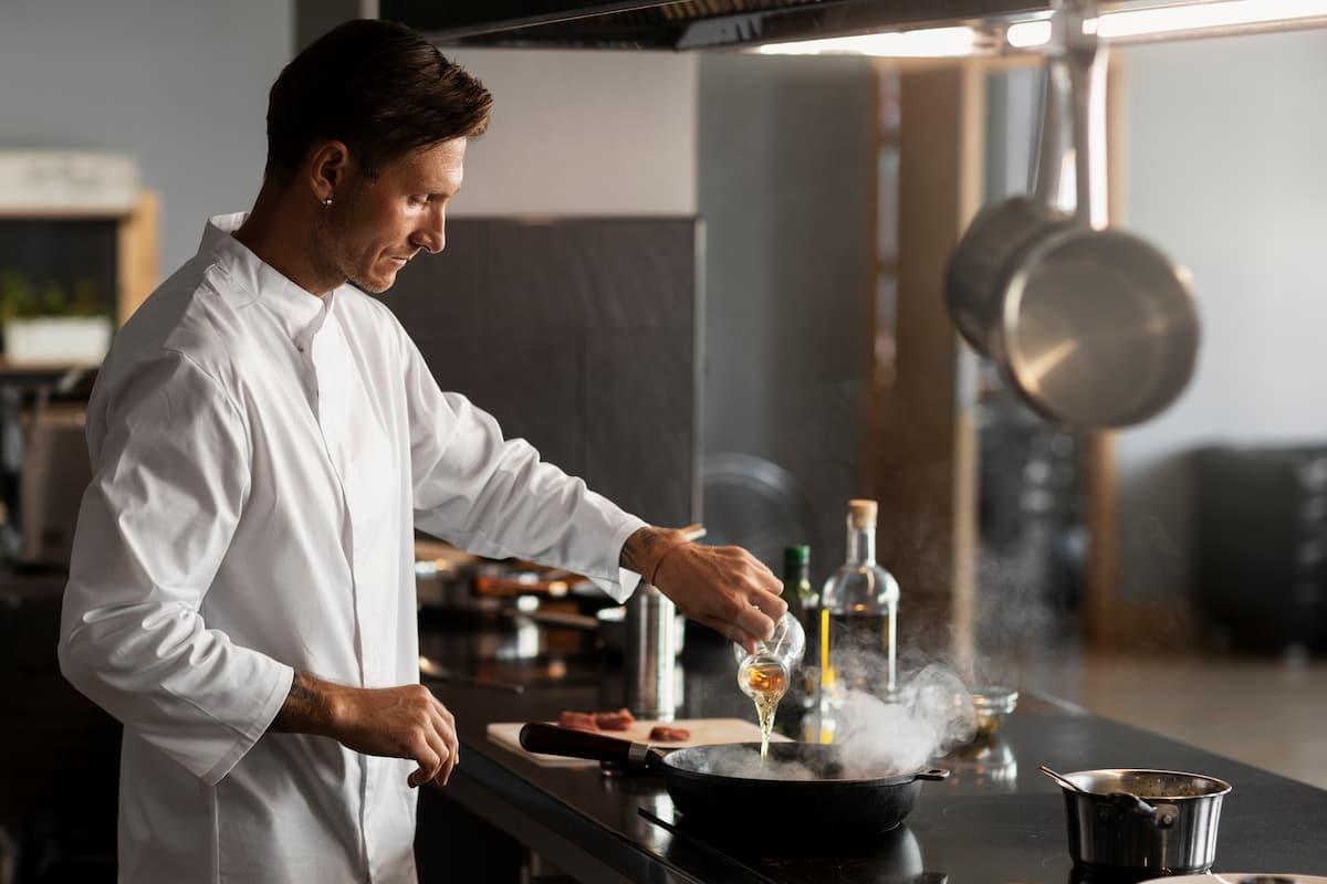 Chef cooking in a modern kitchen, illustrating how CloudKitchens helps food businesses grow with efficient kitchen solutions.