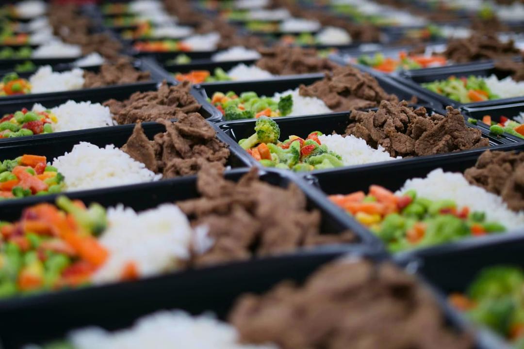 Prepared meal trays in a shared use kitchen showing how shared use kitchens help meal prep businesses grow.