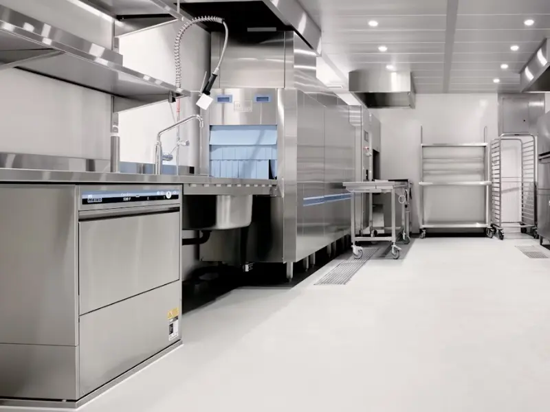 Modern stainless steel kitchen setup with ample space, ideal for guides on how to secure a commercial kitchen lease.