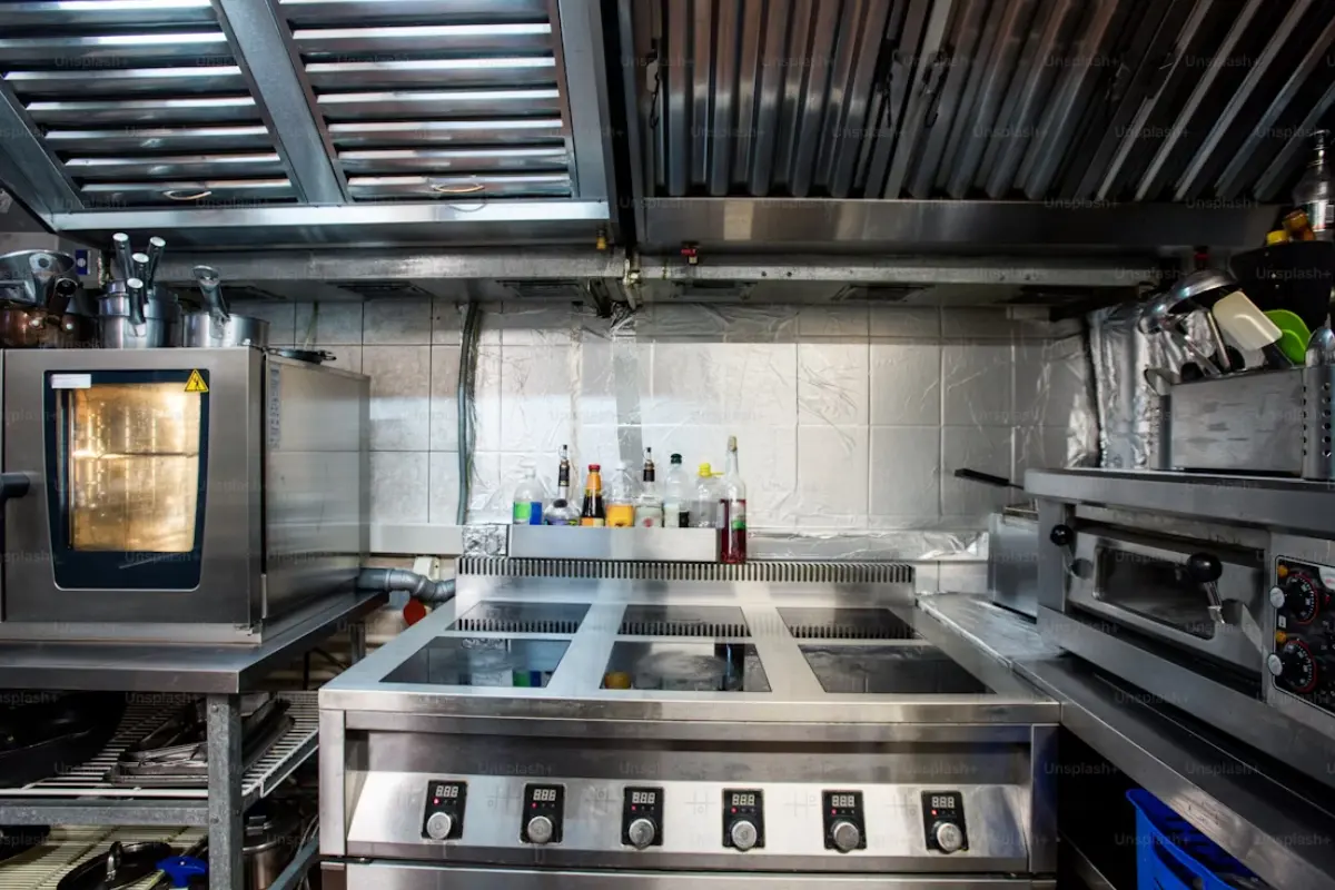 Modern commercial kitchen with stainless steel equipment, ideal for illustrating how to secure a commercial kitchen lease.