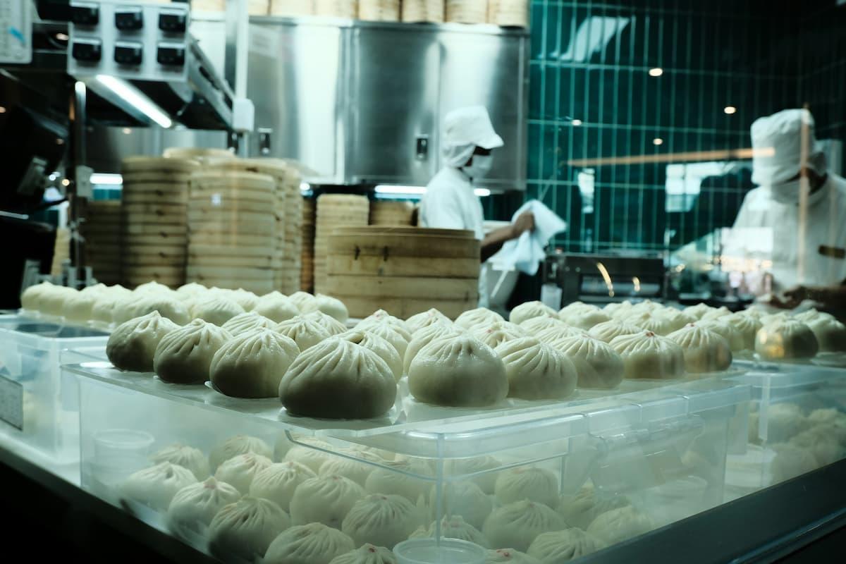 Chefs preparing dumplings in bulk, showcasing strategies to streamline bulk food production operations efficiently.